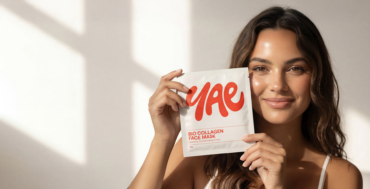 Woman holding a Yae bio collagen face mask against a neutral background